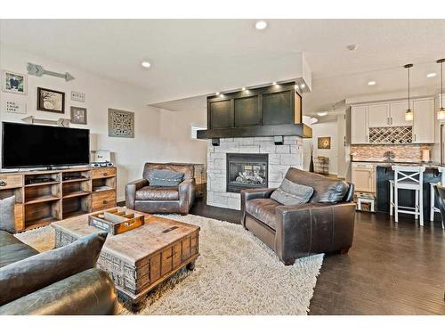 11 Storm Mountain Place, Okotoks, AB - Indoor Photo Showing Living Room With Fireplace