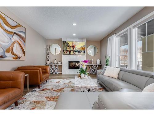 125 Cranbrook Villas Se, Calgary, AB - Indoor Photo Showing Living Room With Fireplace