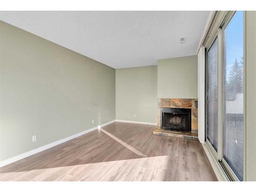 802-2520 Palliser Drive Sw, Calgary, AB - Indoor With Fireplace