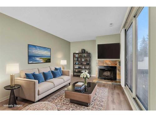 802-2520 Palliser Drive Sw, Calgary, AB - Indoor Photo Showing Living Room With Fireplace