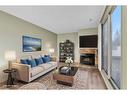 802-2520 Palliser Drive Sw, Calgary, AB  - Indoor Photo Showing Living Room With Fireplace 