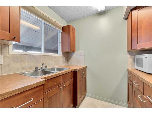 802-2520 Palliser Drive Sw, Calgary, AB - Indoor Photo Showing Kitchen With Double Sink