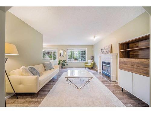 216 Cougar Ridge Drive Sw, Calgary, AB - Indoor Photo Showing Living Room With Fireplace