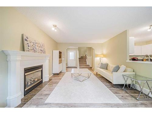 216 Cougar Ridge Drive Sw, Calgary, AB - Indoor Photo Showing Living Room With Fireplace