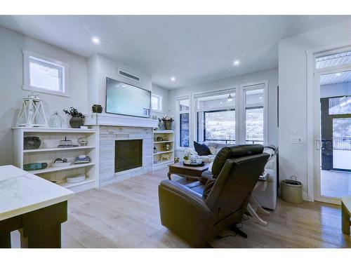 256 Cranbrook Drive Se, Calgary, AB - Indoor Photo Showing Other Room With Fireplace