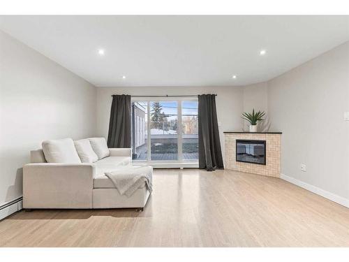 5-1611 26 Avenue Sw, Calgary, AB - Indoor Photo Showing Living Room With Fireplace