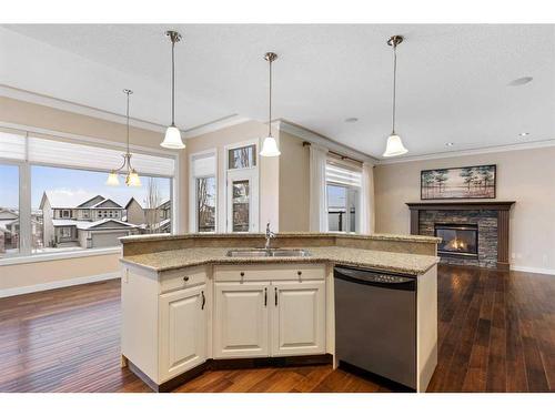 16 Sunset Close, Cochrane, AB - Indoor Photo Showing Kitchen With Fireplace