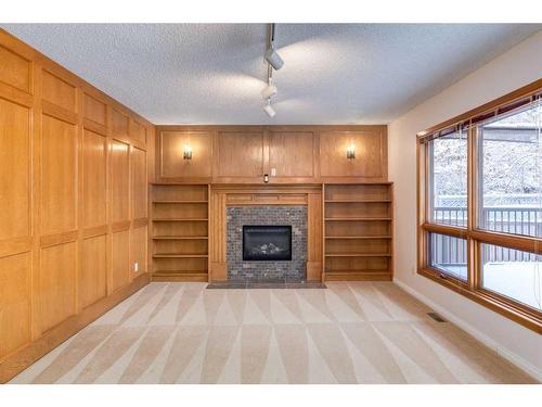 56 Edendale Way Nw, Calgary, AB - Indoor Photo Showing Living Room With Fireplace