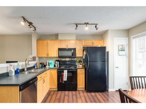 303 Toscana Gardens Nw, Calgary, AB - Indoor Photo Showing Kitchen With Double Sink