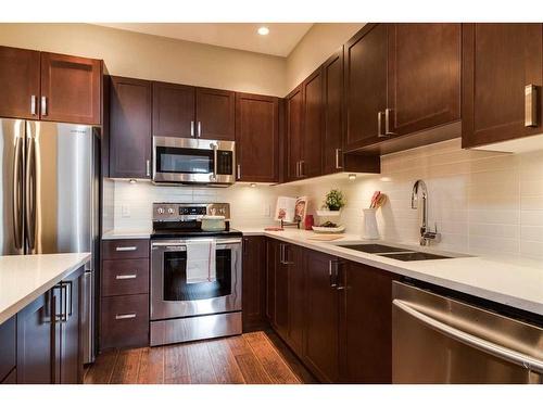 205-22 Auburn Bay Link Se, Calgary, AB - Indoor Photo Showing Kitchen With Stainless Steel Kitchen With Double Sink With Upgraded Kitchen