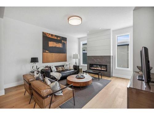 114 Valour Circle Sw, Calgary, AB - Indoor Photo Showing Living Room With Fireplace