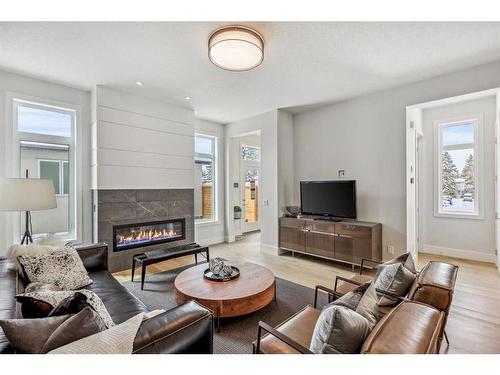 114 Valour Circle Sw, Calgary, AB - Indoor Photo Showing Living Room With Fireplace