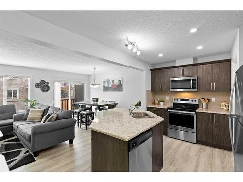 345 Hillcrest Square Sw, Airdrie, AB - Indoor Photo Showing Kitchen With Double Sink