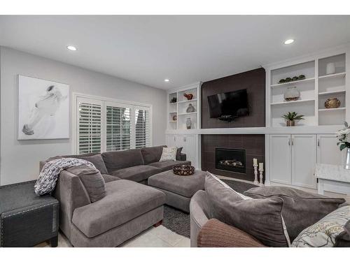 1093 Coopers Drive Sw, Airdrie, AB - Indoor Photo Showing Living Room With Fireplace