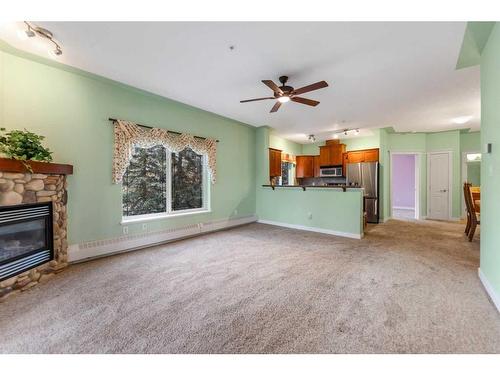 438-20 Discovery Ridge Close Sw, Calgary, AB - Indoor Photo Showing Living Room With Fireplace