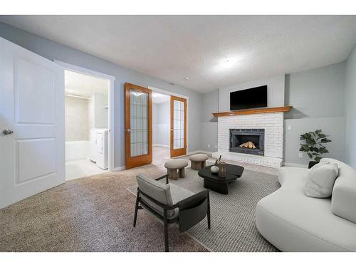 50 Martindale Drive Ne, Calgary, AB - Indoor Photo Showing Living Room With Fireplace