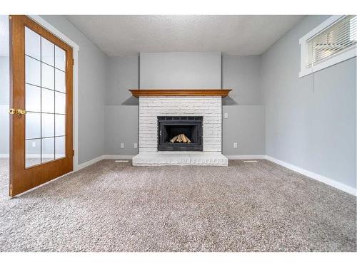 50 Martindale Drive Ne, Calgary, AB - Indoor Photo Showing Living Room With Fireplace