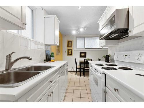 101-836 4 Avenue Nw, Calgary, AB - Indoor Photo Showing Kitchen With Double Sink