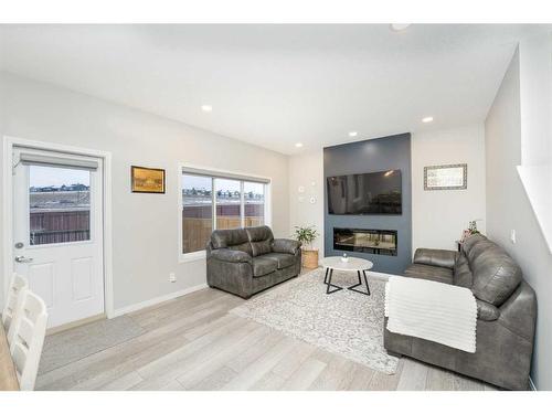 174 Carringsby Way Nw, Calgary, AB - Indoor Photo Showing Living Room With Fireplace