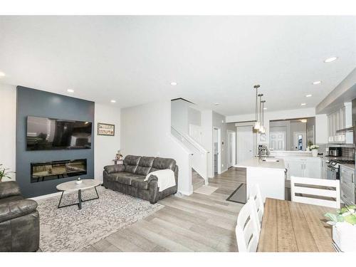 174 Carringsby Way Nw, Calgary, AB - Indoor Photo Showing Living Room With Fireplace