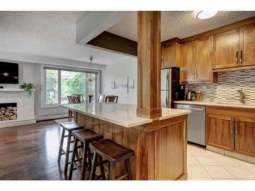 302-1731 9A Street Sw, Calgary, AB - Indoor Photo Showing Kitchen With Fireplace