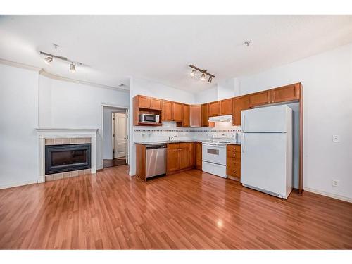 115-333 Riverfront Avenue Se, Calgary, AB - Indoor Photo Showing Kitchen With Fireplace