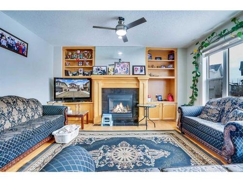 63 New Brighton Close Se, Calgary, AB - Indoor Photo Showing Living Room With Fireplace