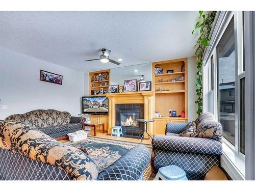 63 New Brighton Close Se, Calgary, AB - Indoor Photo Showing Living Room With Fireplace