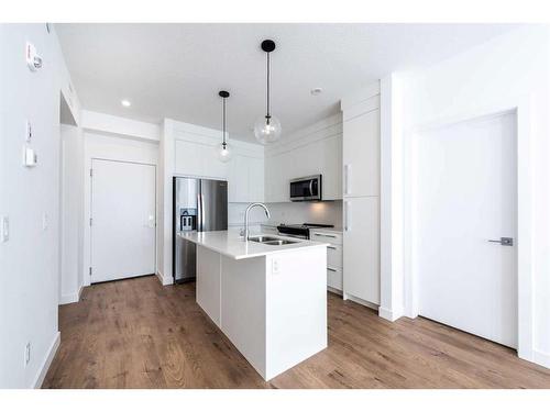 3407-111 Wolf Creek Drive Se, Calgary, AB - Indoor Photo Showing Kitchen With Double Sink With Upgraded Kitchen