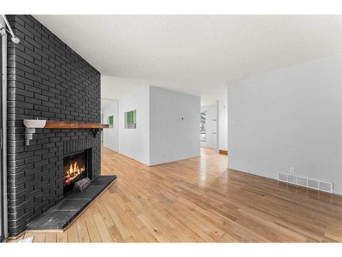 7-2210 Oakmoor Drive Sw, Calgary, AB - Indoor Photo Showing Other Room With Fireplace