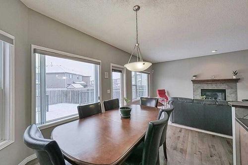 200 Saddlecrest Way Ne, Calgary, AB - Indoor Photo Showing Dining Room With Fireplace