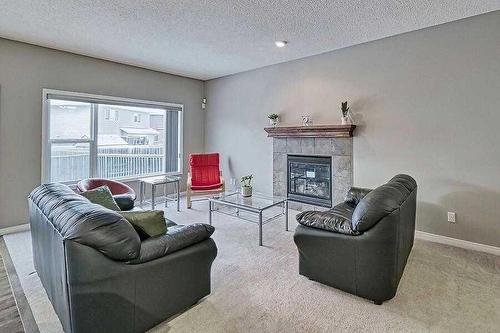 200 Saddlecrest Way Ne, Calgary, AB - Indoor Photo Showing Living Room With Fireplace