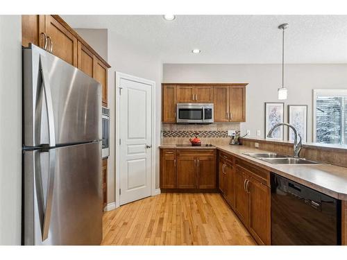 113 Tucker Circle, Okotoks, AB - Indoor Photo Showing Kitchen With Double Sink