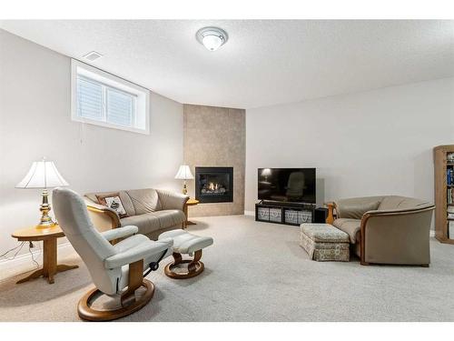 113 Tucker Circle, Okotoks, AB - Indoor Photo Showing Living Room With Fireplace