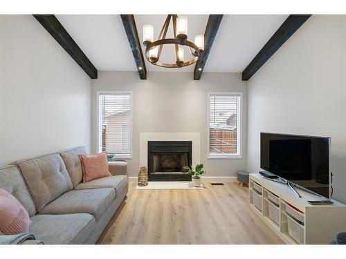 66 Erin Crescent Se, Calgary, AB - Indoor Photo Showing Living Room With Fireplace