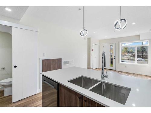 308-156 Park Street, Cochrane, AB - Indoor Photo Showing Kitchen With Double Sink