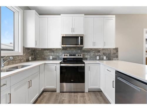 128 Heartland Boulevard, Cochrane, AB - Indoor Photo Showing Kitchen With Double Sink