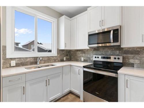 128 Heartland Boulevard, Cochrane, AB - Indoor Photo Showing Kitchen With Double Sink With Upgraded Kitchen