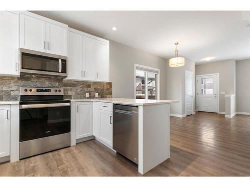 128 Heartland Boulevard, Cochrane, AB - Indoor Photo Showing Kitchen With Upgraded Kitchen