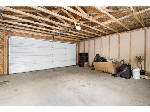 128 Heartland Boulevard, Cochrane, AB - Indoor Photo Showing Garage