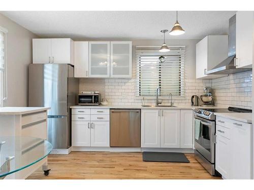 84 Glendale Way, Cochrane, AB - Indoor Photo Showing Kitchen With Stainless Steel Kitchen With Upgraded Kitchen