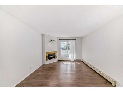 12-2812 Edenwold Heights Nw, Calgary, AB - Indoor With Fireplace