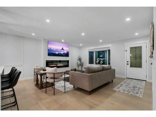 7027 Huntbourne Green Ne, Calgary, AB - Indoor Photo Showing Other Room With Fireplace