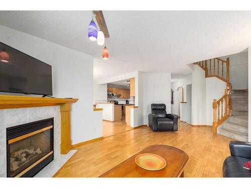 224 Tuscarora Heights Nw, Calgary, AB - Indoor Photo Showing Living Room With Fireplace