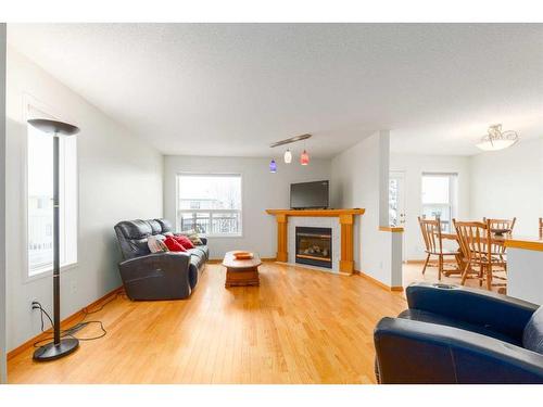 224 Tuscarora Heights Nw, Calgary, AB - Indoor Photo Showing Living Room With Fireplace