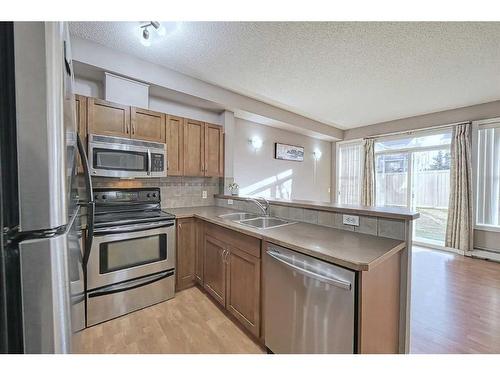 2101-211 Aspen Stone Boulevard Sw, Calgary, AB - Indoor Photo Showing Kitchen With Stainless Steel Kitchen With Double Sink