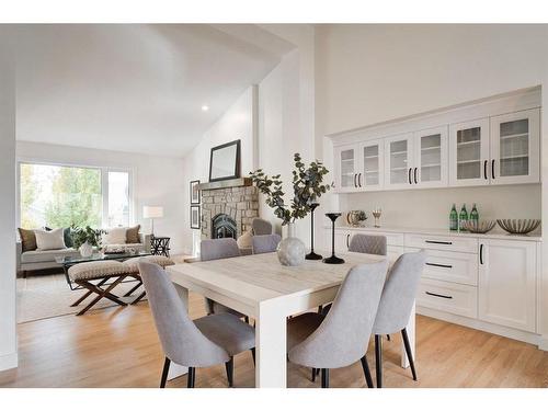 14 West Hall Place, Cochrane, AB - Indoor Photo Showing Dining Room With Fireplace