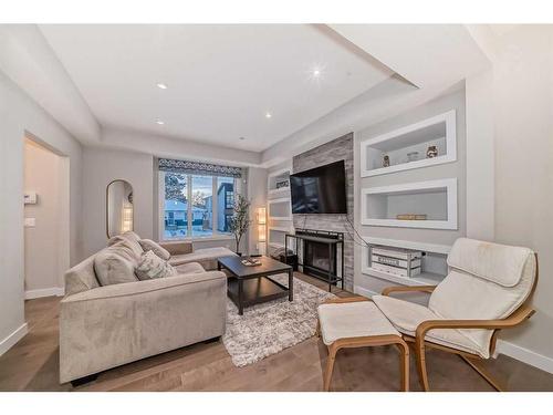 1-2420 30 Street Sw, Calgary, AB - Indoor Photo Showing Living Room With Fireplace