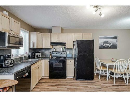 140 Royal Oak Gardens Nw, Calgary, AB - Indoor Photo Showing Kitchen With Double Sink