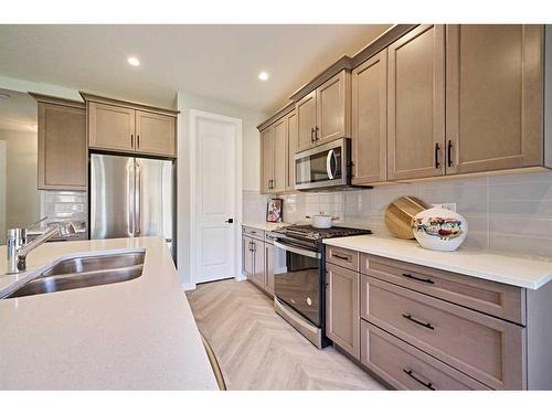 48 Shawnee Green Sw, Calgary, AB - Indoor Photo Showing Kitchen With Stainless Steel Kitchen With Double Sink